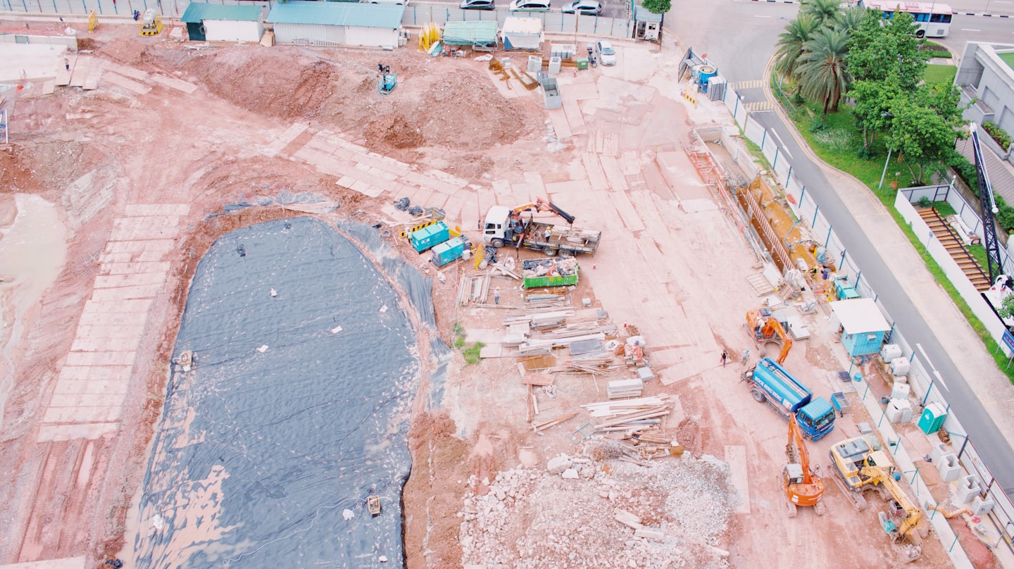 Vehículos de construcción nivelan la tierra en un sitio de construcción activo.